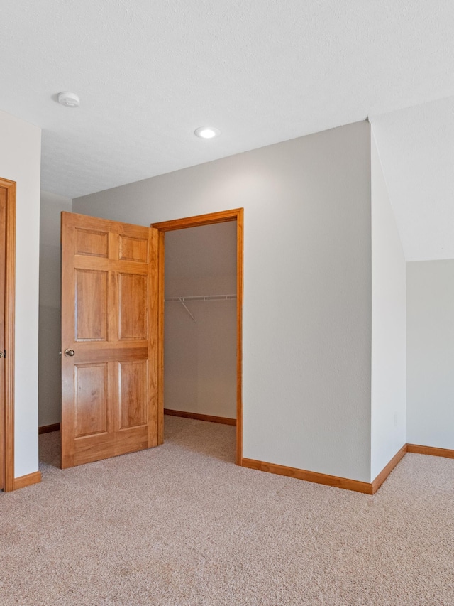 unfurnished bedroom with a closet and carpet floors