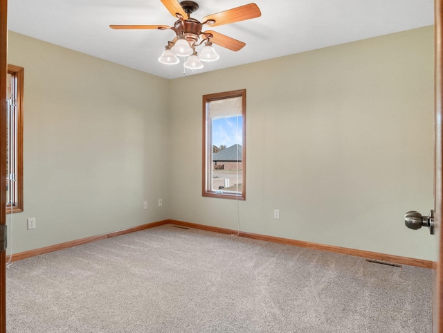 carpeted spare room with ceiling fan