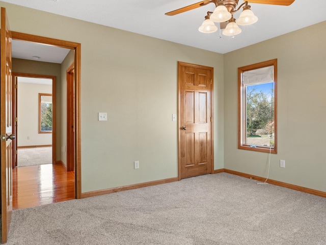 carpeted spare room with ceiling fan