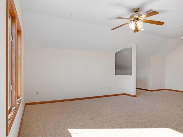 bonus room with vaulted ceiling, light carpet, and ceiling fan