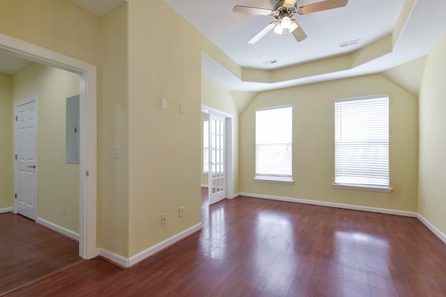 spare room with electric panel, dark hardwood / wood-style flooring, and ceiling fan