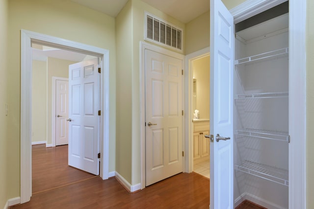 hallway with hardwood / wood-style floors