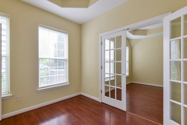 empty room with french doors and dark wood-type flooring