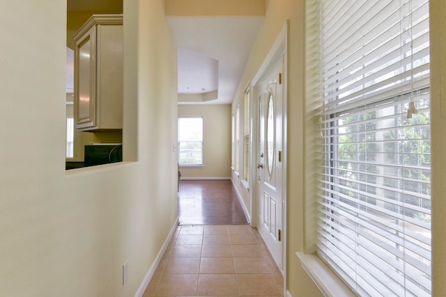 hall with light tile patterned floors