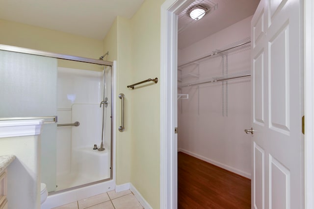 bathroom with walk in shower, vanity, toilet, and hardwood / wood-style flooring