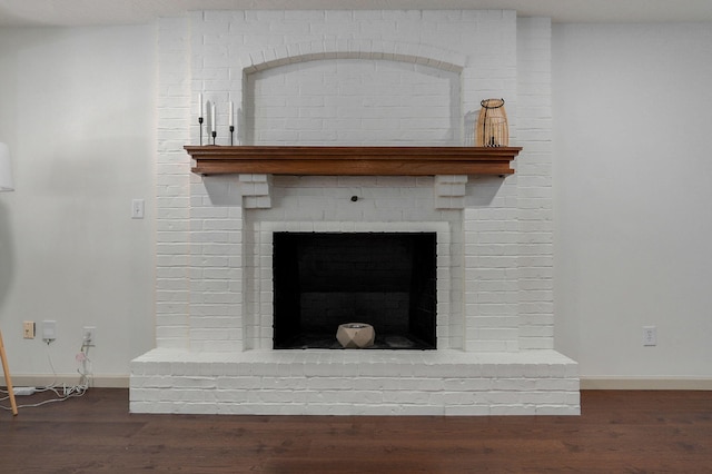 details featuring hardwood / wood-style floors and a fireplace