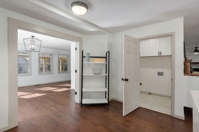 interior space with hardwood / wood-style floors, a textured ceiling, and an inviting chandelier