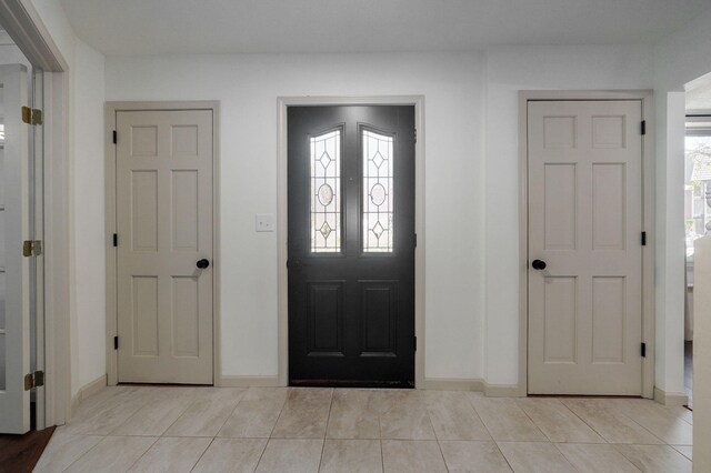 foyer entrance with plenty of natural light and light tile patterned floors