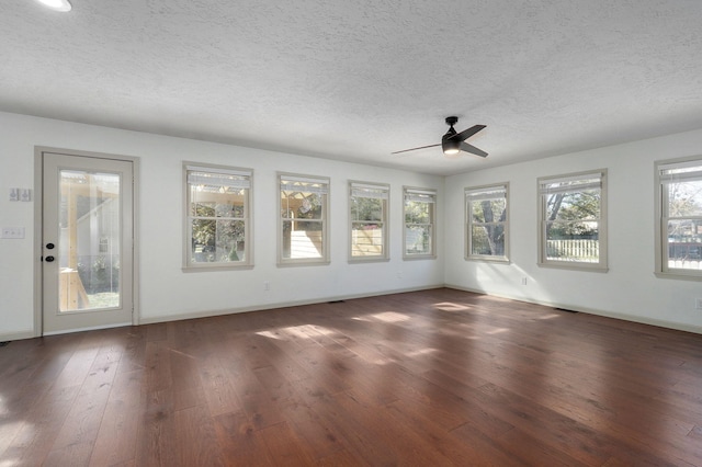 spare room featuring a textured ceiling, dark hardwood / wood-style floors, and ceiling fan