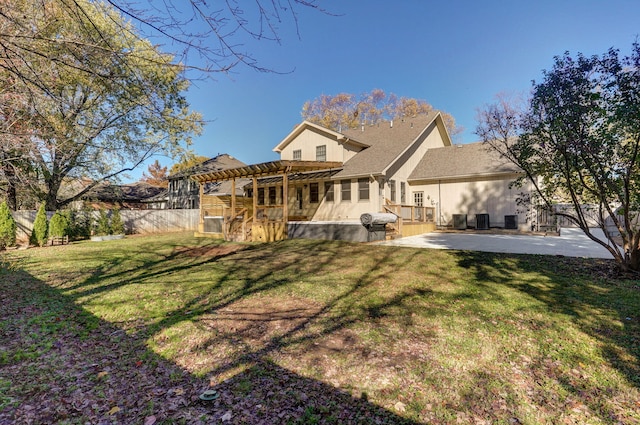 rear view of property featuring a patio, a pergola, and a lawn