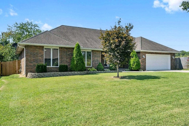 ranch-style home with a front yard and a garage