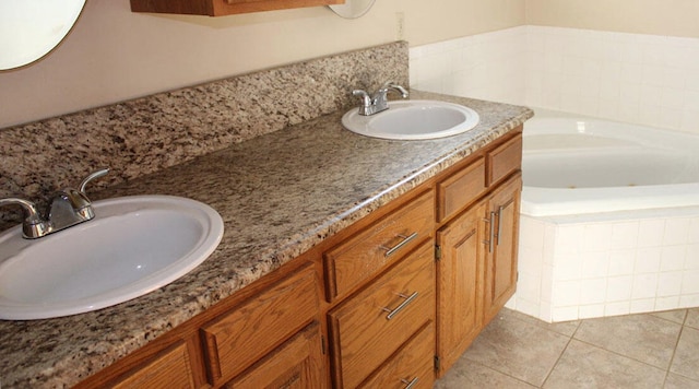 bathroom featuring tiled bath, tile patterned flooring, and vanity