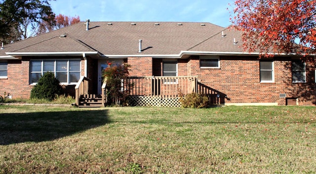 back of property with a yard and a deck