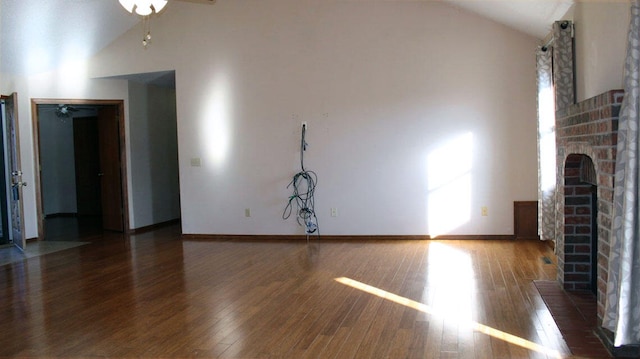 unfurnished living room featuring ceiling fan, a fireplace, high vaulted ceiling, and dark hardwood / wood-style floors