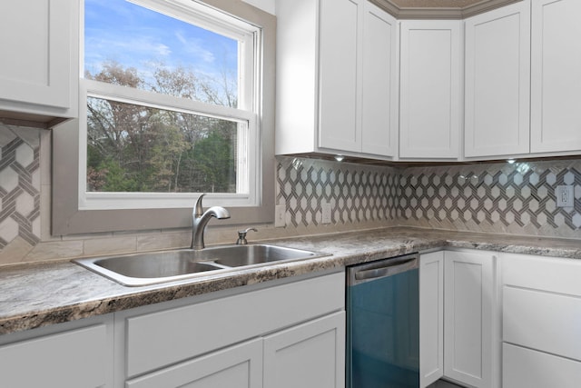 kitchen with white cabinets, stainless steel dishwasher, and sink