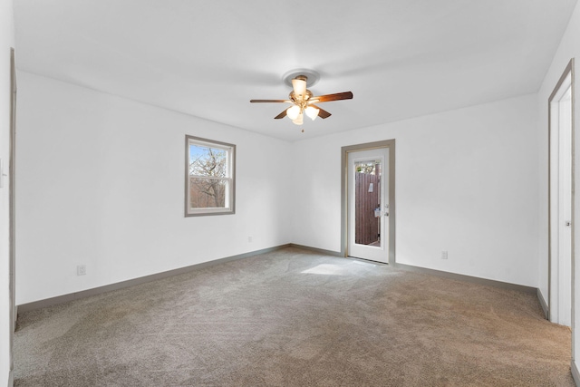 unfurnished room featuring ceiling fan and carpet