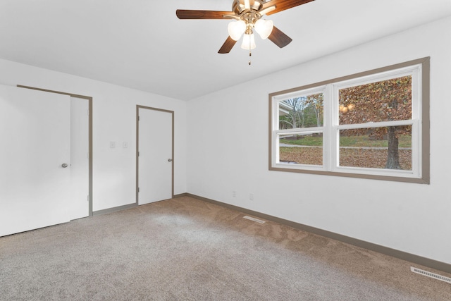 unfurnished bedroom with carpet flooring and ceiling fan