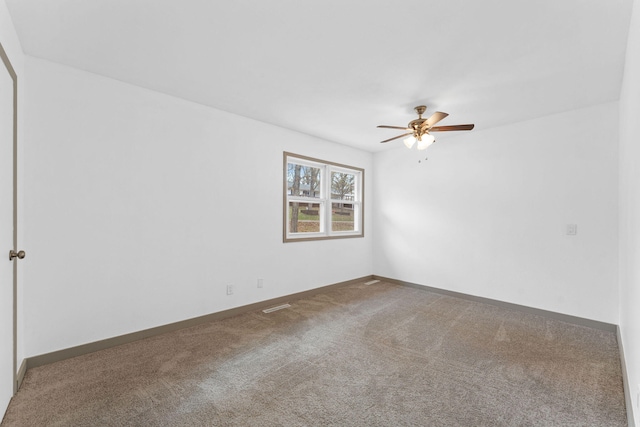 spare room featuring carpet and ceiling fan