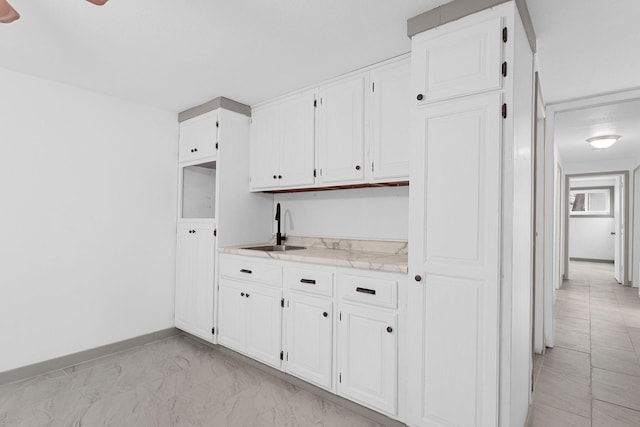 kitchen with white cabinetry and sink