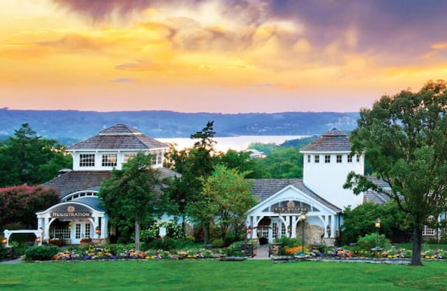 exterior space featuring a lawn and a mountain view