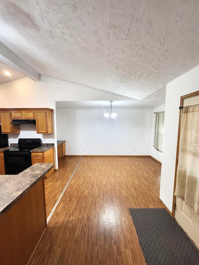 kitchen featuring lofted ceiling with beams, light hardwood / wood-style floors, a notable chandelier, and electric range