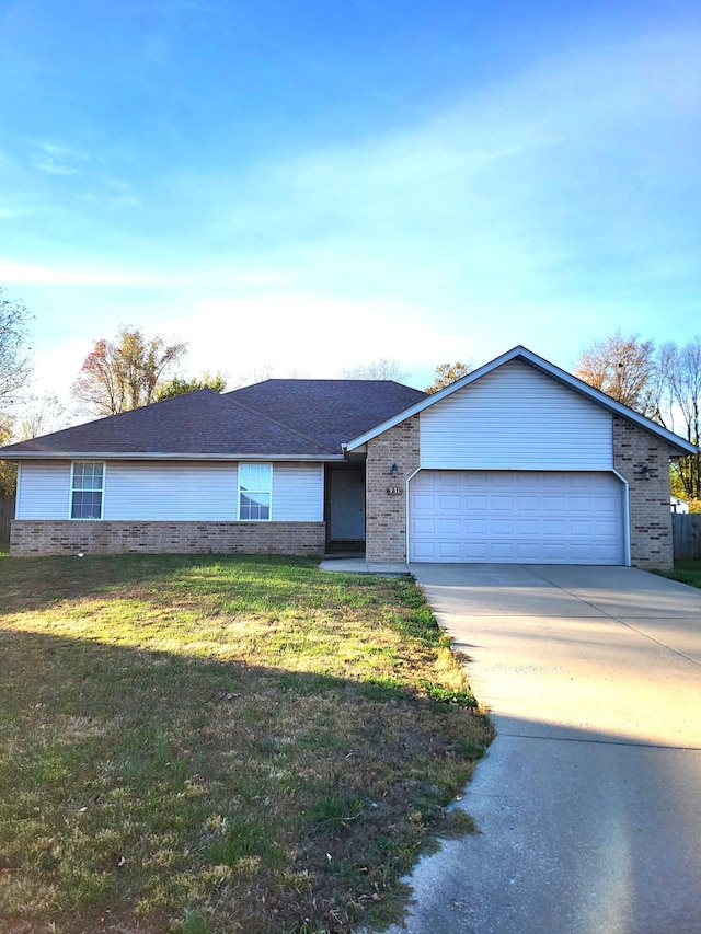 single story home with a garage and a front yard