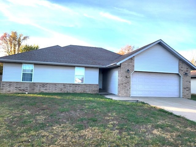 single story home featuring a garage and a front yard