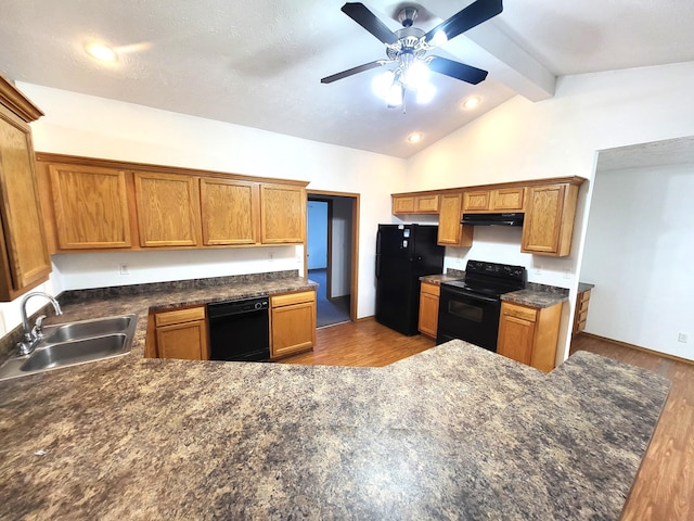 kitchen with black appliances, vaulted ceiling with beams, sink, hardwood / wood-style floors, and ceiling fan