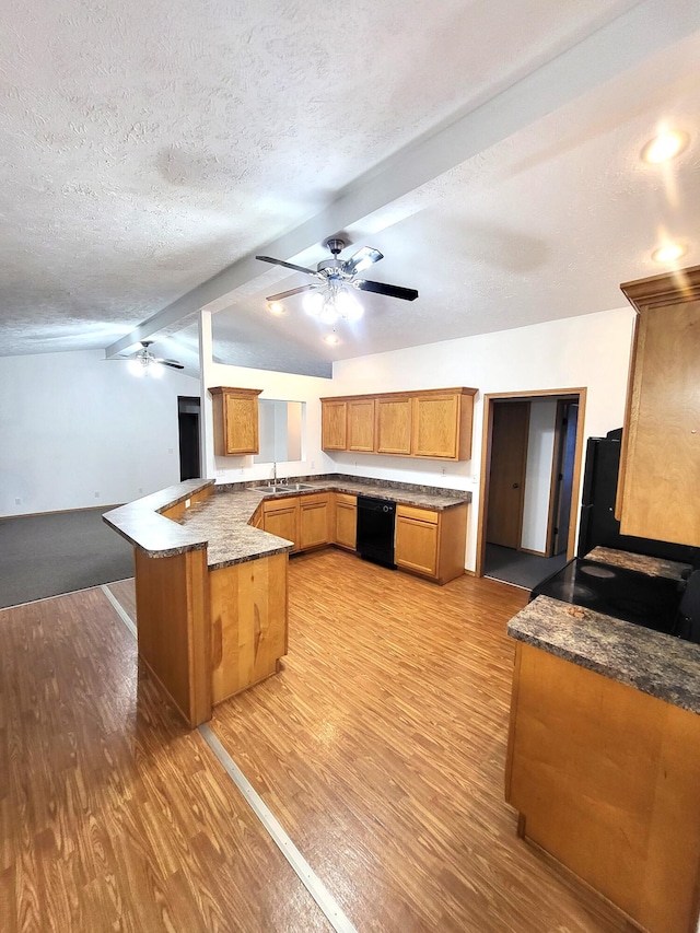 kitchen featuring light hardwood / wood-style floors, kitchen peninsula, a textured ceiling, dishwasher, and lofted ceiling with beams