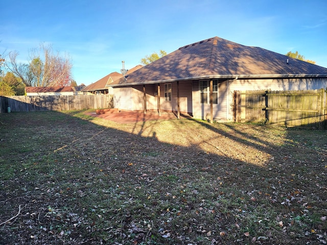 rear view of property featuring a yard