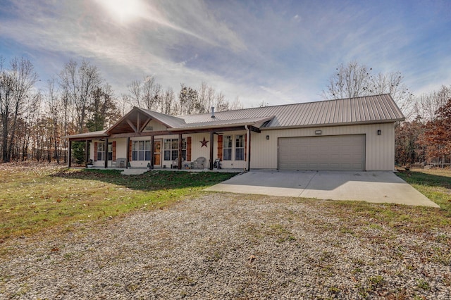 ranch-style house featuring a garage, a porch, and a front yard