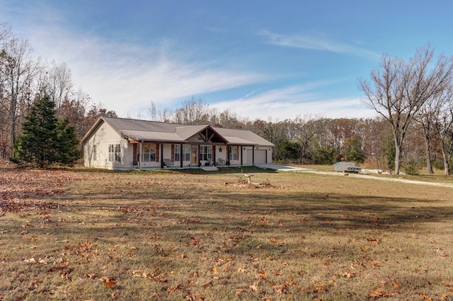 ranch-style home featuring a garage, a front lawn, and a porch