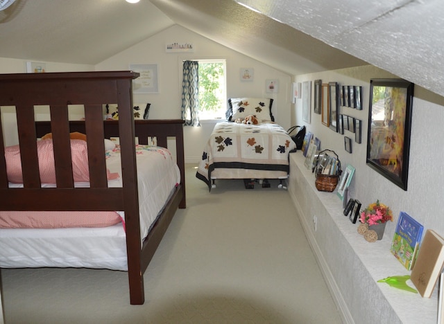 bedroom with vaulted ceiling and carpet flooring