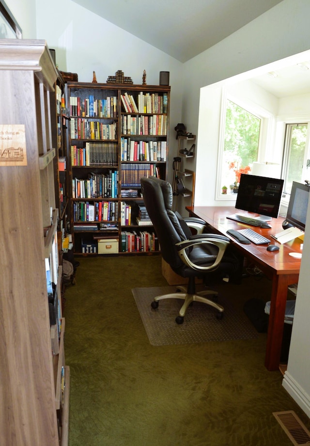 carpeted office featuring lofted ceiling