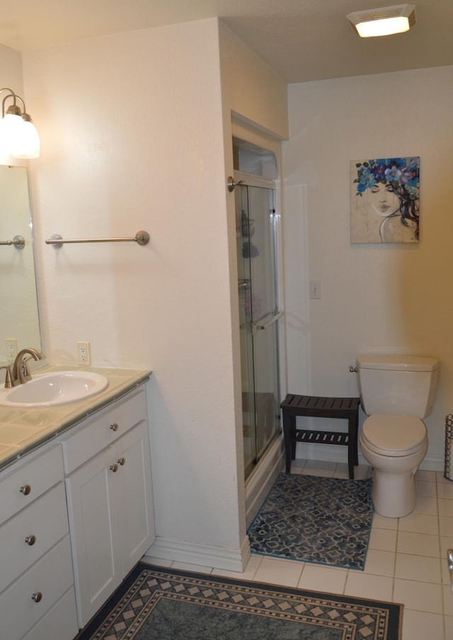 bathroom with vanity, walk in shower, tile patterned floors, and toilet