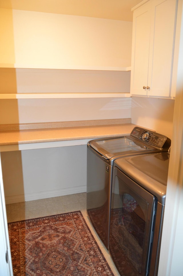 clothes washing area with cabinets, tile patterned flooring, and independent washer and dryer