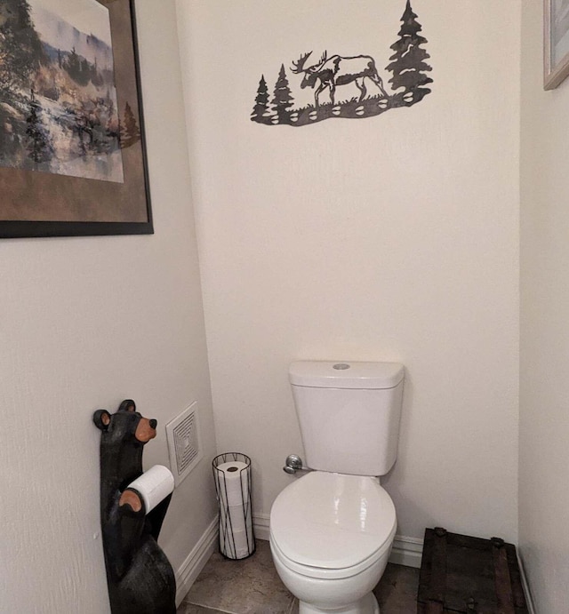 bathroom with toilet and tile patterned floors