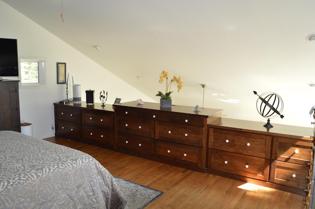 bedroom featuring lofted ceiling and dark hardwood / wood-style flooring