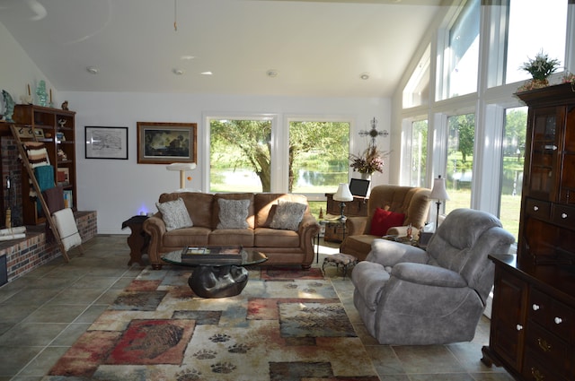 tiled living room with a healthy amount of sunlight and lofted ceiling