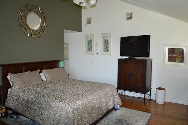 bedroom featuring ceiling fan, dark hardwood / wood-style floors, and high vaulted ceiling