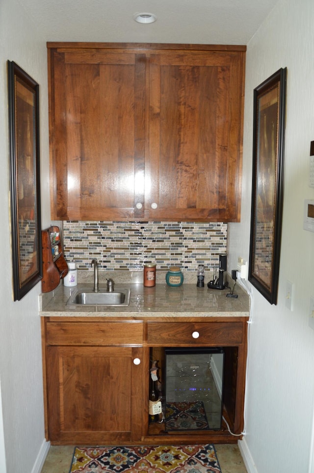 bar featuring tasteful backsplash and sink