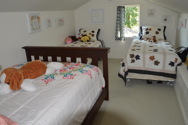 carpeted bedroom with lofted ceiling