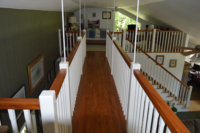 stairway with lofted ceiling and wood-type flooring