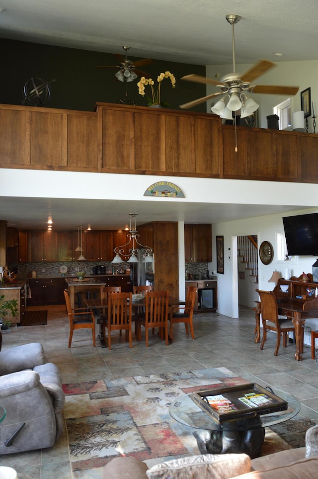 living room with ceiling fan with notable chandelier