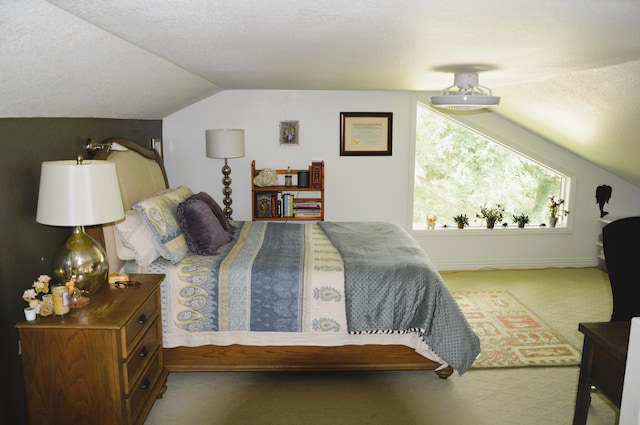 bedroom with carpet, a textured ceiling, and vaulted ceiling