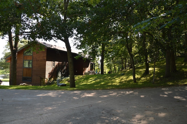 view of property exterior featuring a lawn