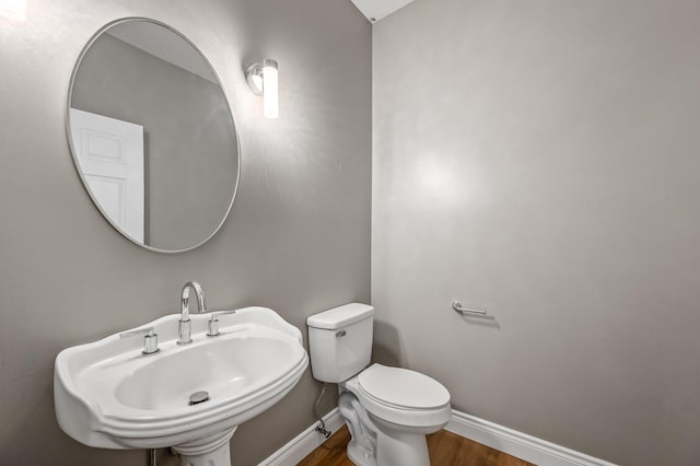 bathroom featuring hardwood / wood-style floors, sink, and toilet