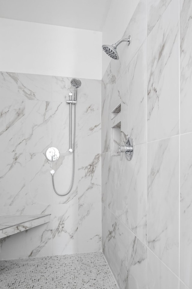 bathroom with tiled shower