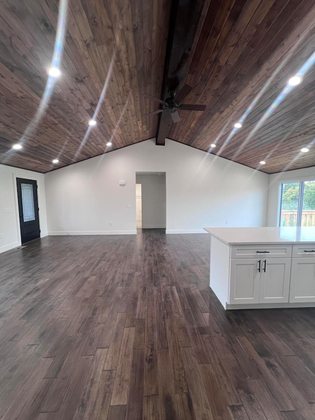 unfurnished room featuring wood ceiling, dark wood finished floors, lofted ceiling with beams, and baseboards