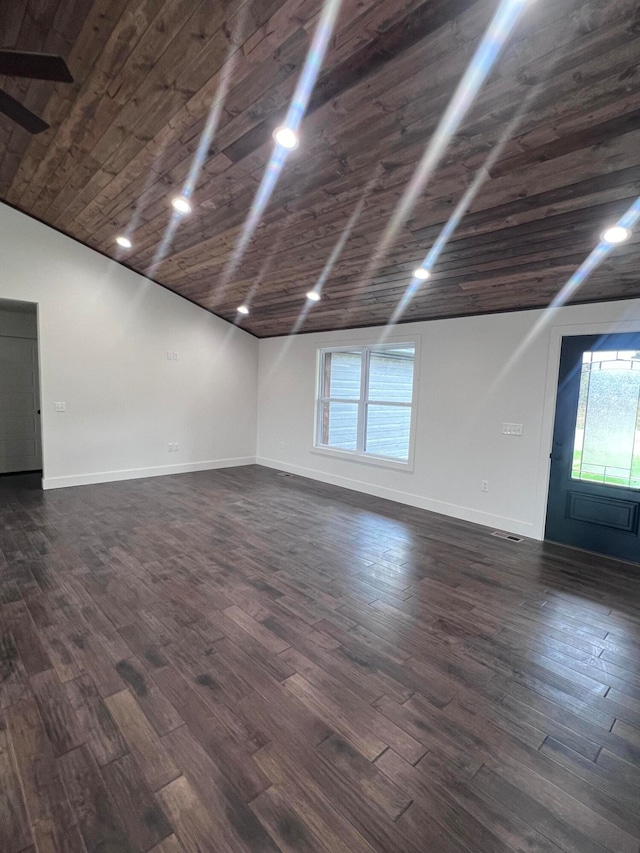 spare room with visible vents, wood ceiling, vaulted ceiling, baseboards, and dark wood finished floors